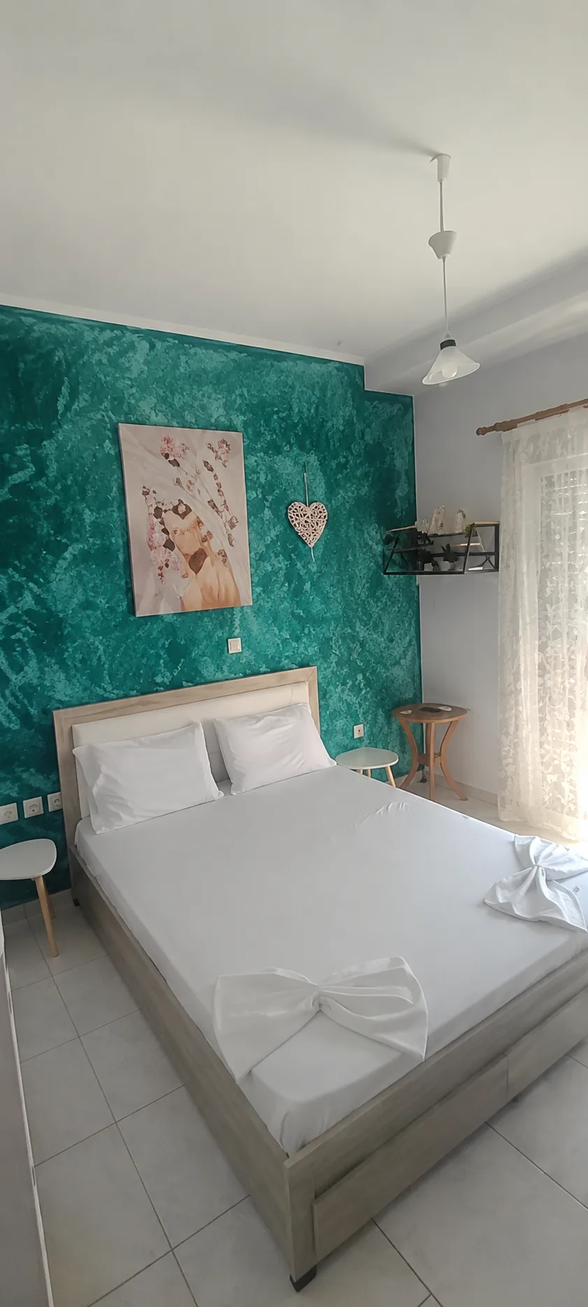 Emerald room with white bed