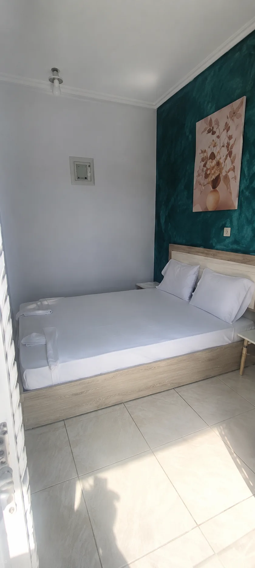 Double room with emerald feature wall